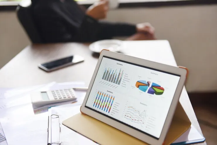 A laptop computer sitting on top of a wooden desk.