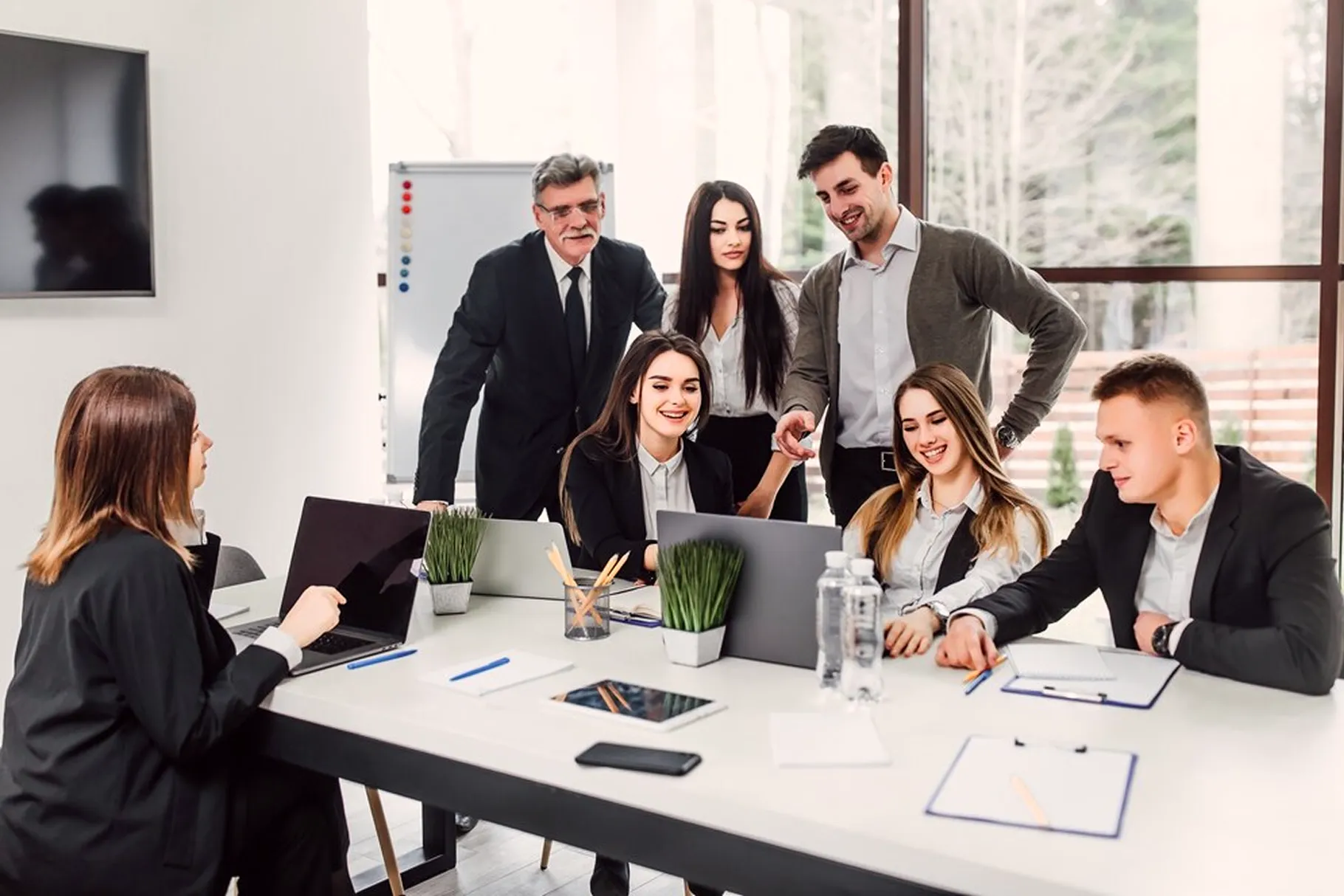 A group of people standing around a table.