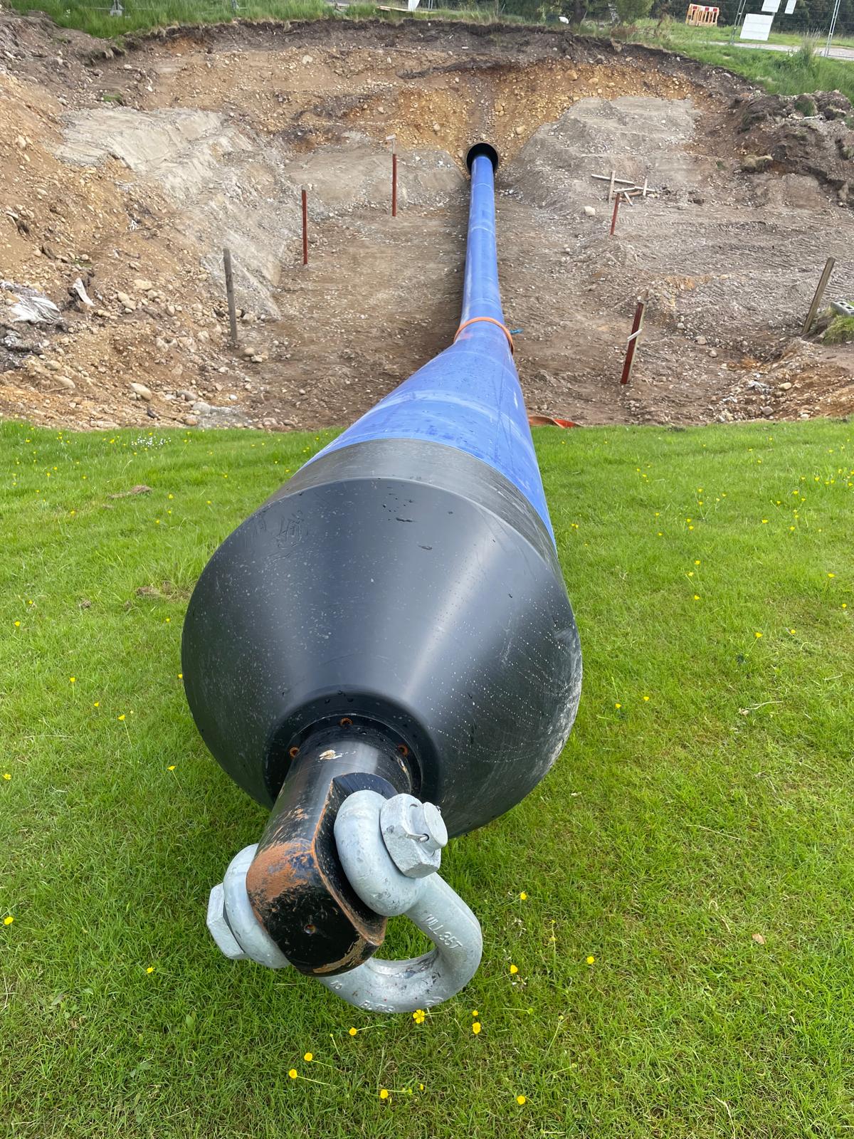 Image of a water mains connection being installed by our professional utilities team. We can see a pipe being introduced into a perfectly drilled hole.