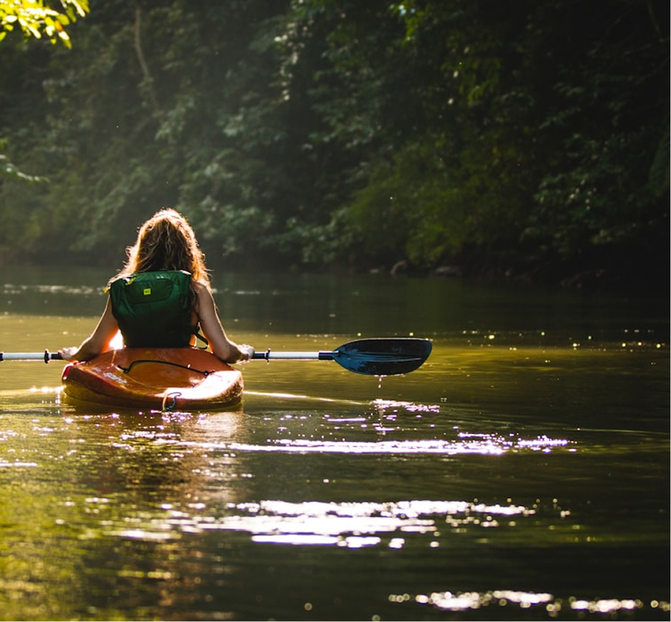 Woman rowing a kayak enjoying experiential travel