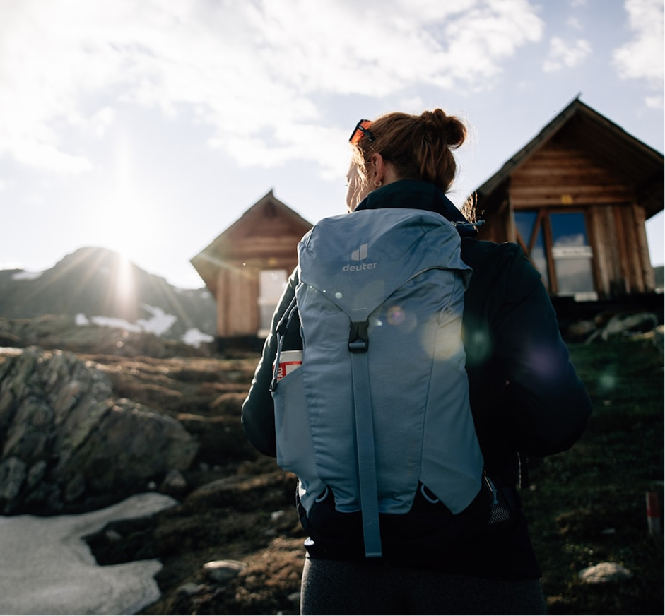Woman hiking a mountain enjoying experiential travel