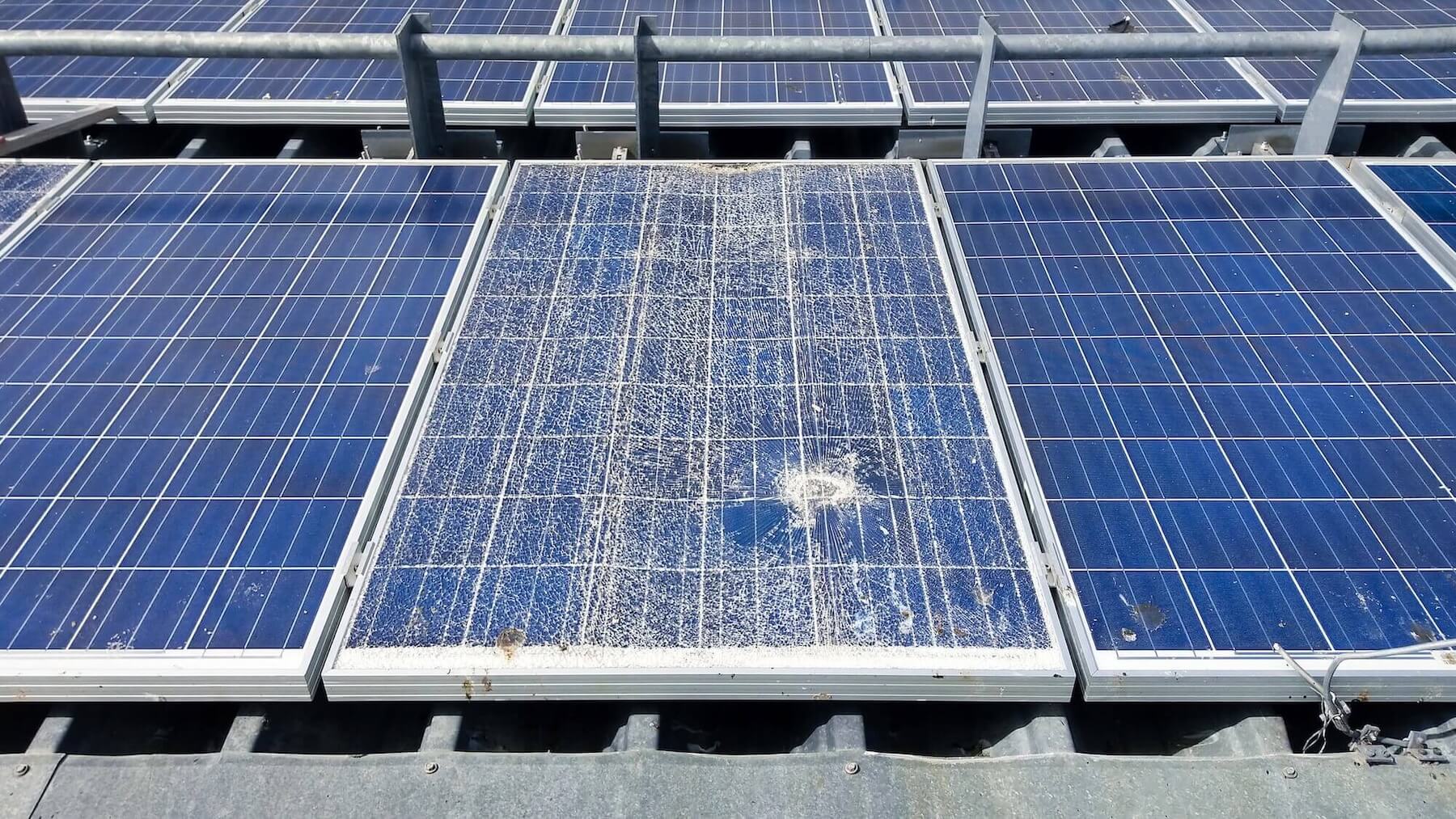 Beschädigtes Solarpanel mit Glasbruch in Photovoltaikanlage zeigt Risse und Splitter