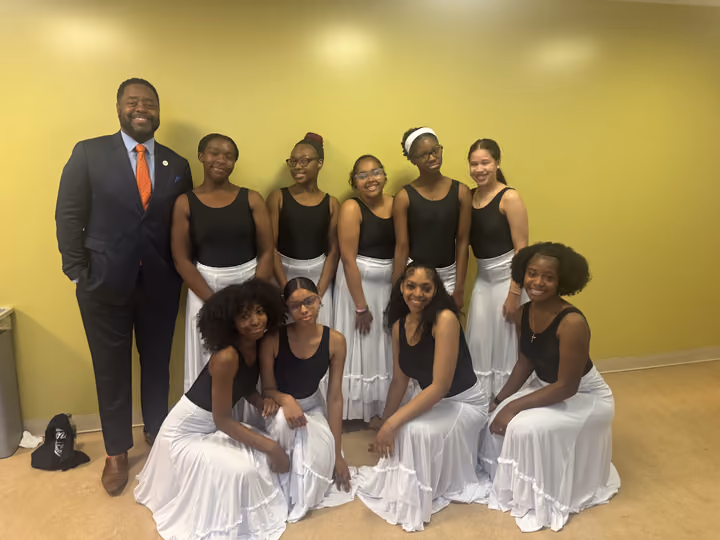 Group posing in black and white attire










