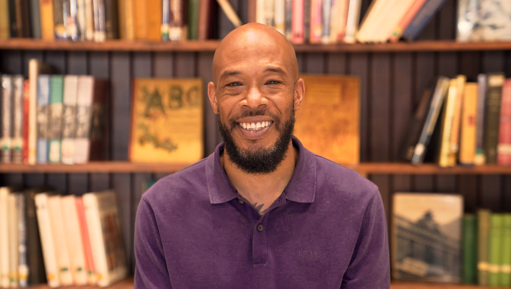Smiling man in purple shirt