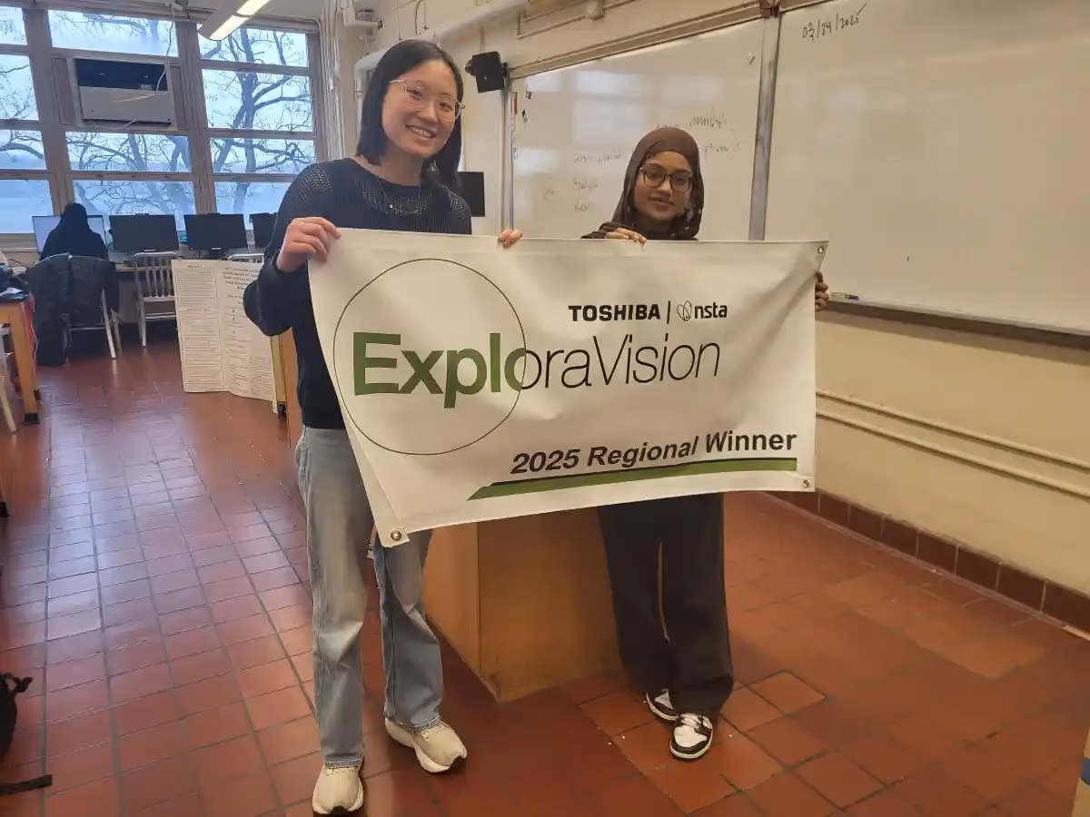 Students holding ExploraVision banner