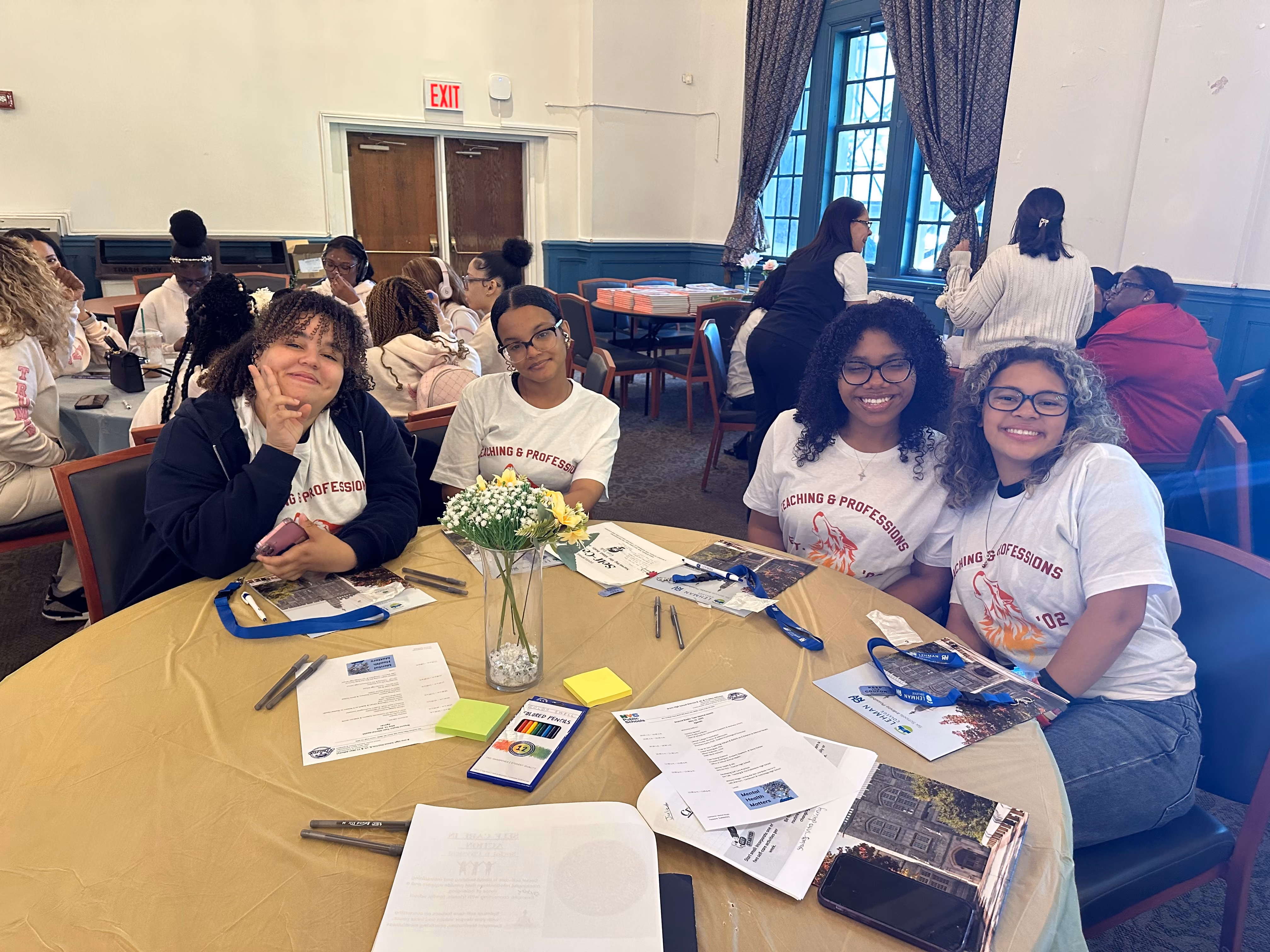 Students at round table smiling