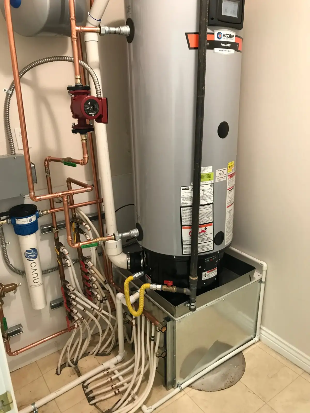 New water heater being installed in a utility room