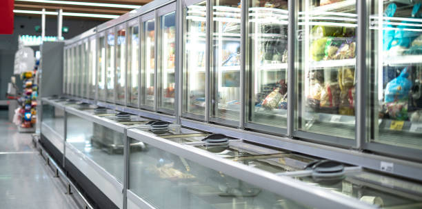 A row of commercial upright freezers, likely found in a supermarket.