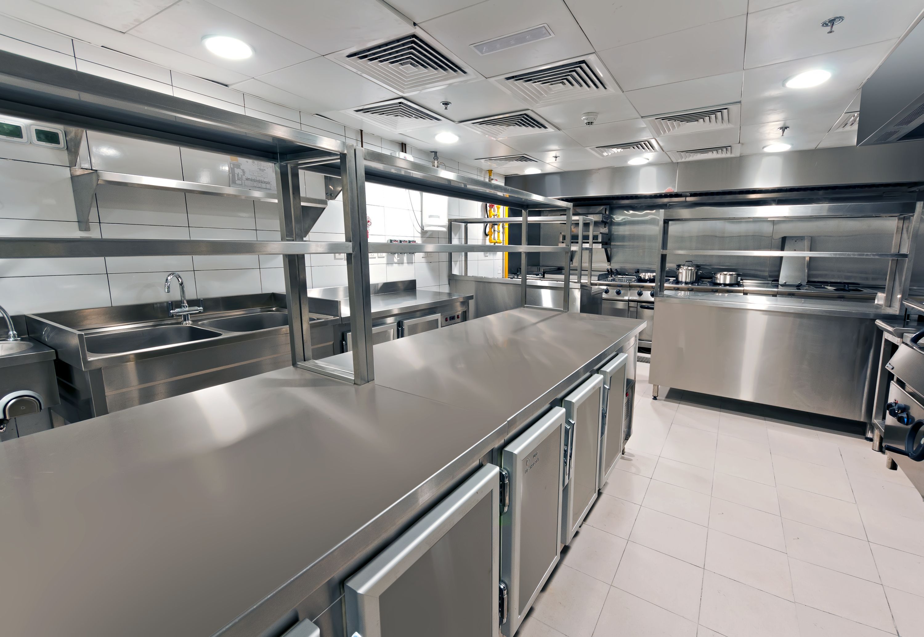 The image shows a clean and modern commercial kitchen, likely designed for a restaurant, hotel, or other foodservice establishment.