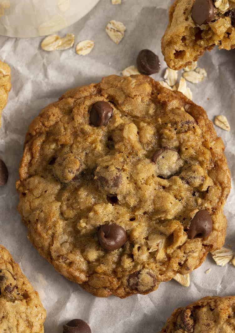 An Oatmeal Chocolate Chip cookie next to a glass of milk