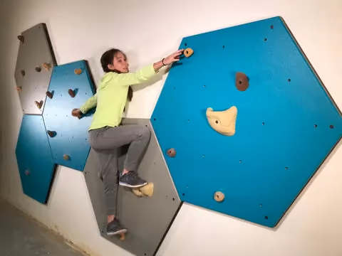 girl climbing on a home climbing wall