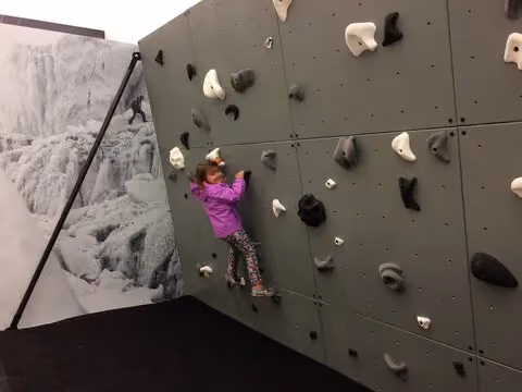 small child climbing on a wall