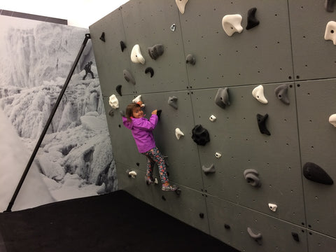 small child climbing on a wall