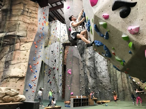 Man climbs on a bouldering wall