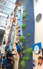 Actor Jason Momoa of Aquaman helps the kids climb during the grand opening