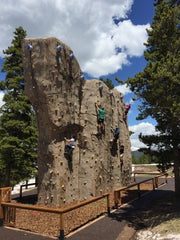 Rock climbers scale the new granite-like climbing wall at Vail.