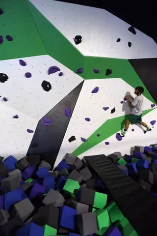 Cimber in the bouldering wall at Spider Monkey Extreme Airsports in Aurora, CO