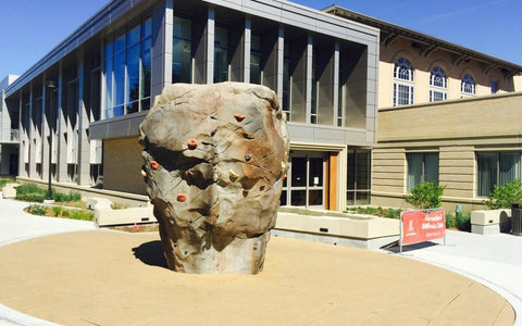 realistic climbing boulder outside of a colle recreation center