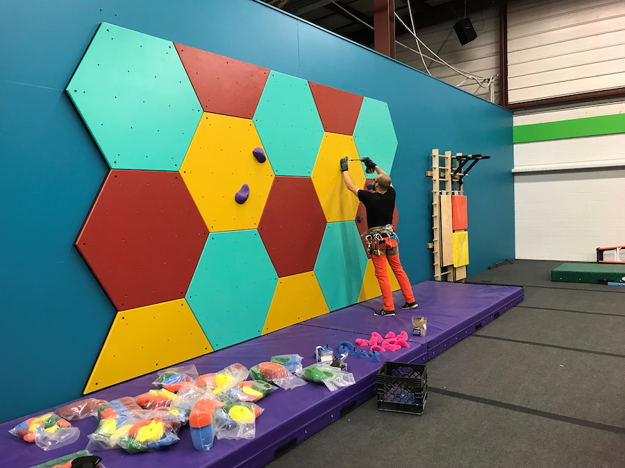 Thinking about a garage climbing wall? Learn how to plan for temperature, space, air quality, T-nut placement, training options, safety, and budget.
