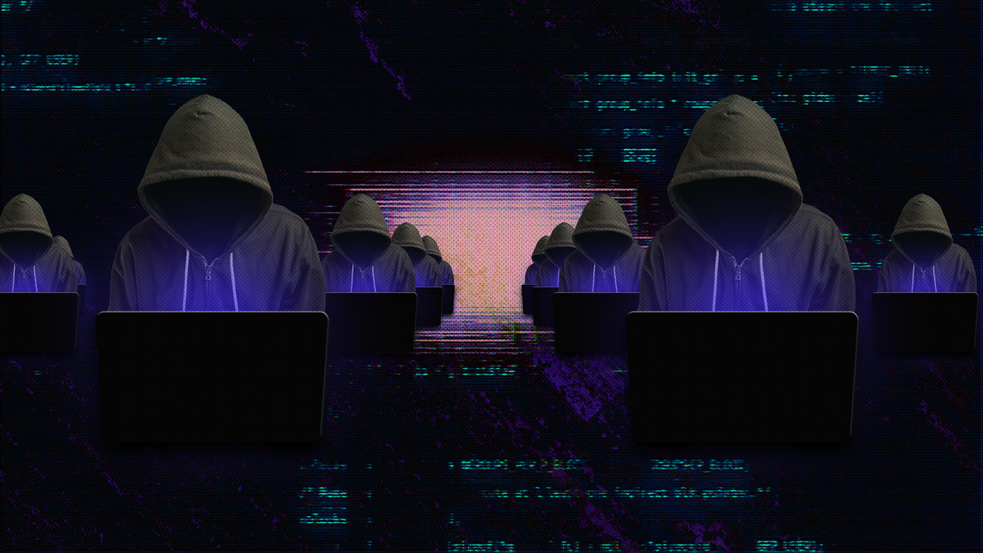 rows of hooded people in front of laptops