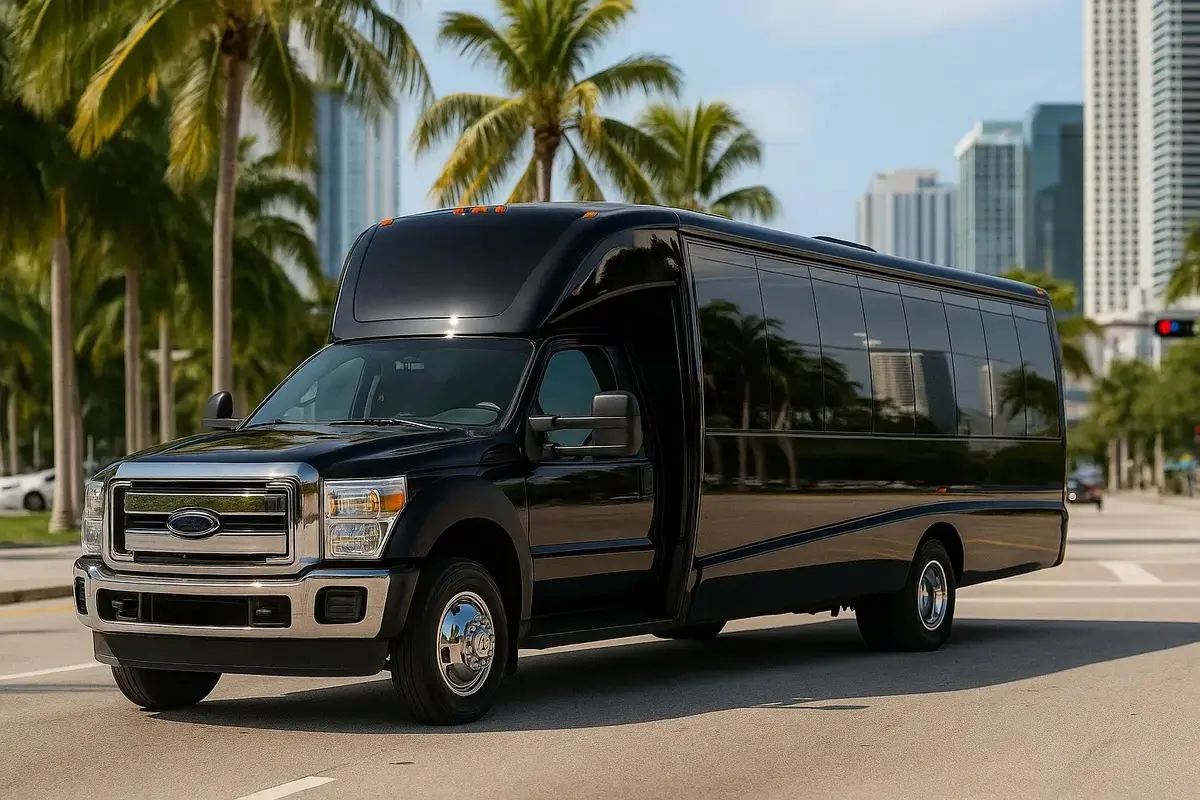 Black 24-passenger Ford Mini Bus parked in Miami with palm trees and modern skyline in the background – luxury group transportation and private chauffeur service.