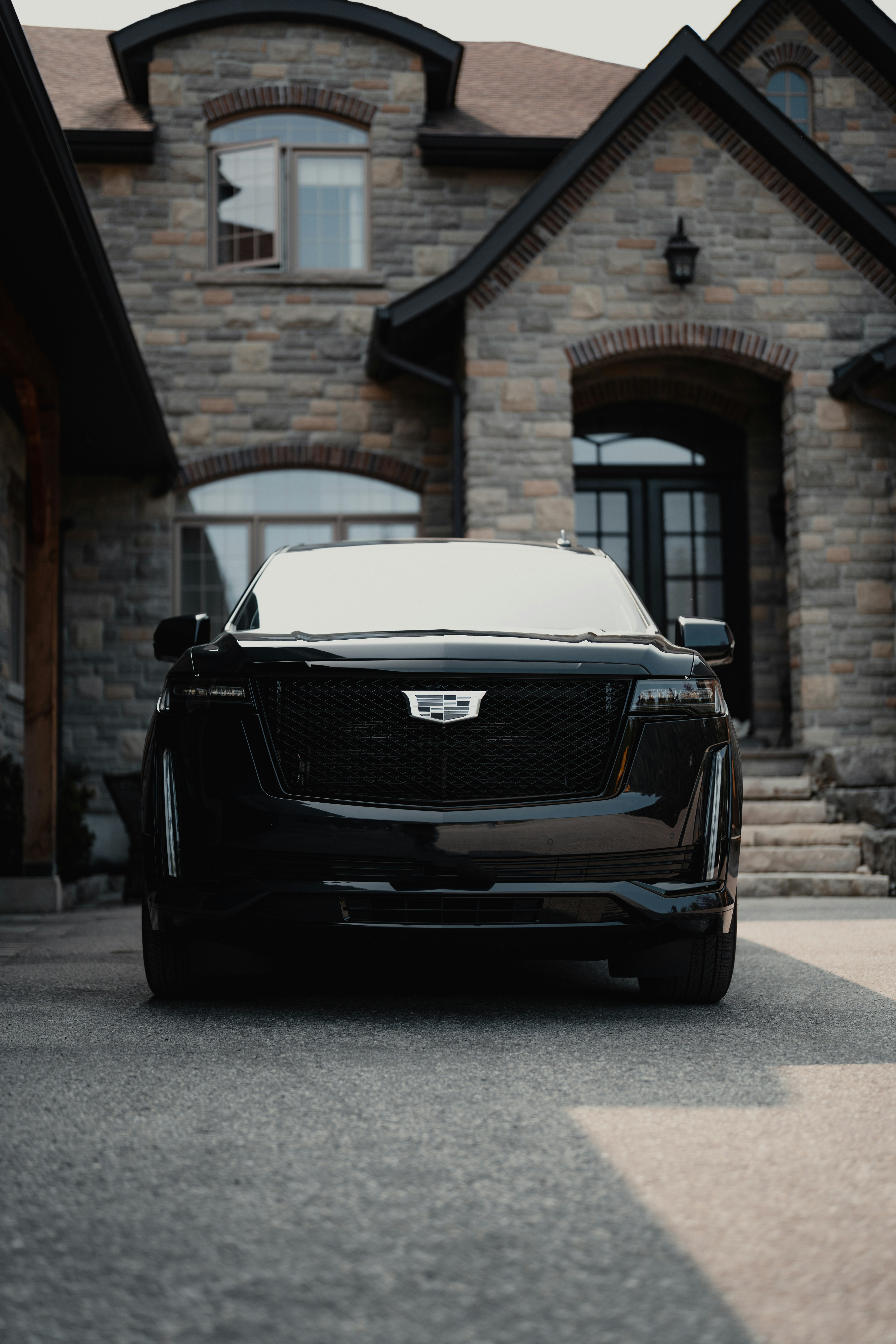Chauffeur in black suit loading a Mercedes-Benz S-Class sedan with black luggage – luxury airport transfer and executive chauffeur service