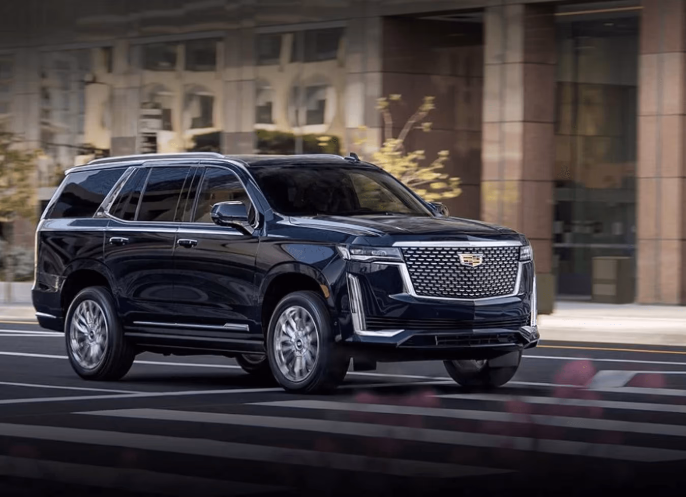 Chauffeur in black suit loading a Mercedes-Benz S-Class sedan with black luggage – luxury airport transfer and executive chauffeur service