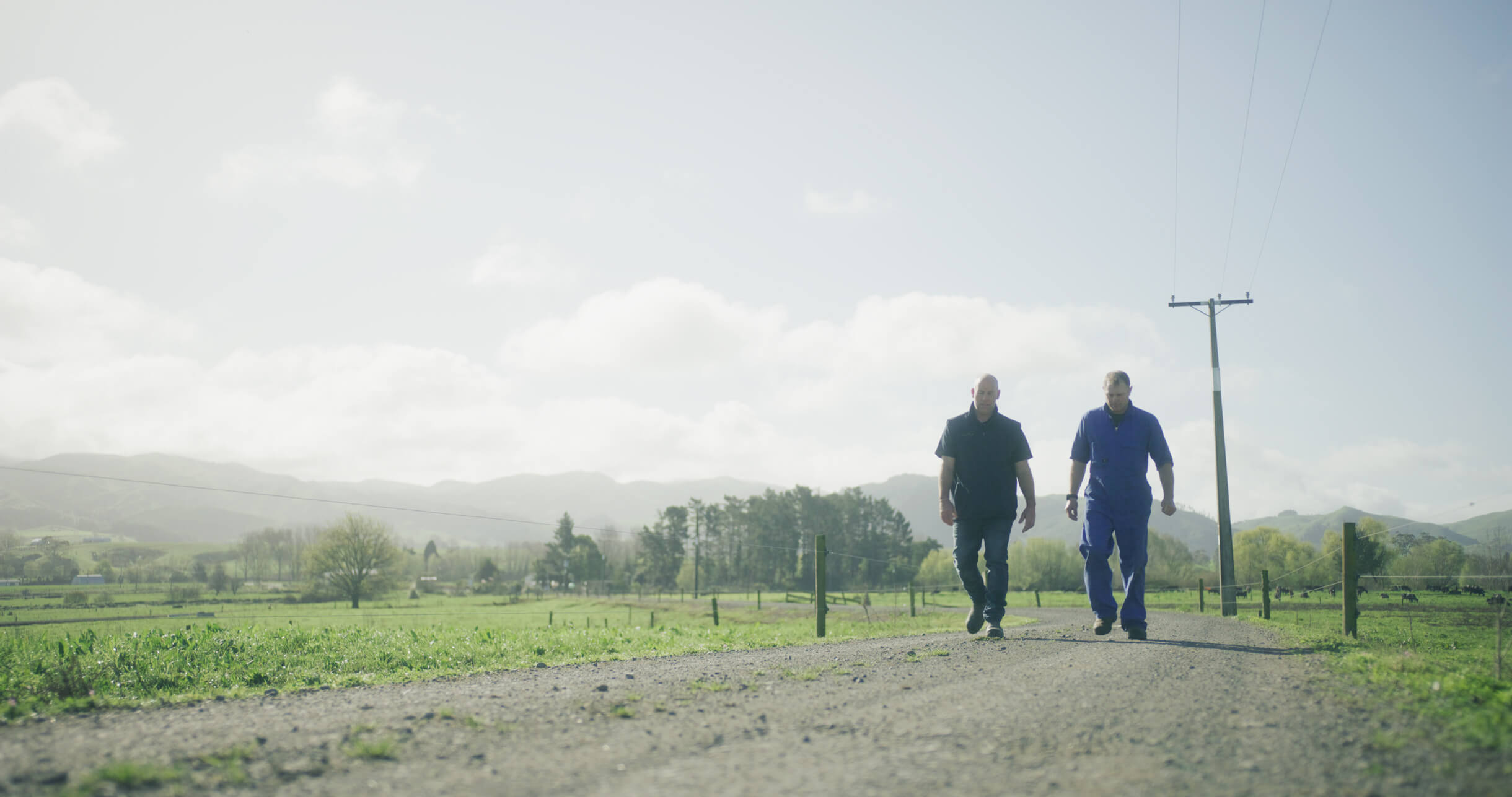 Watch the video of how we helped Jarrah when his farm flooded. An image of two men walking up a farm track.