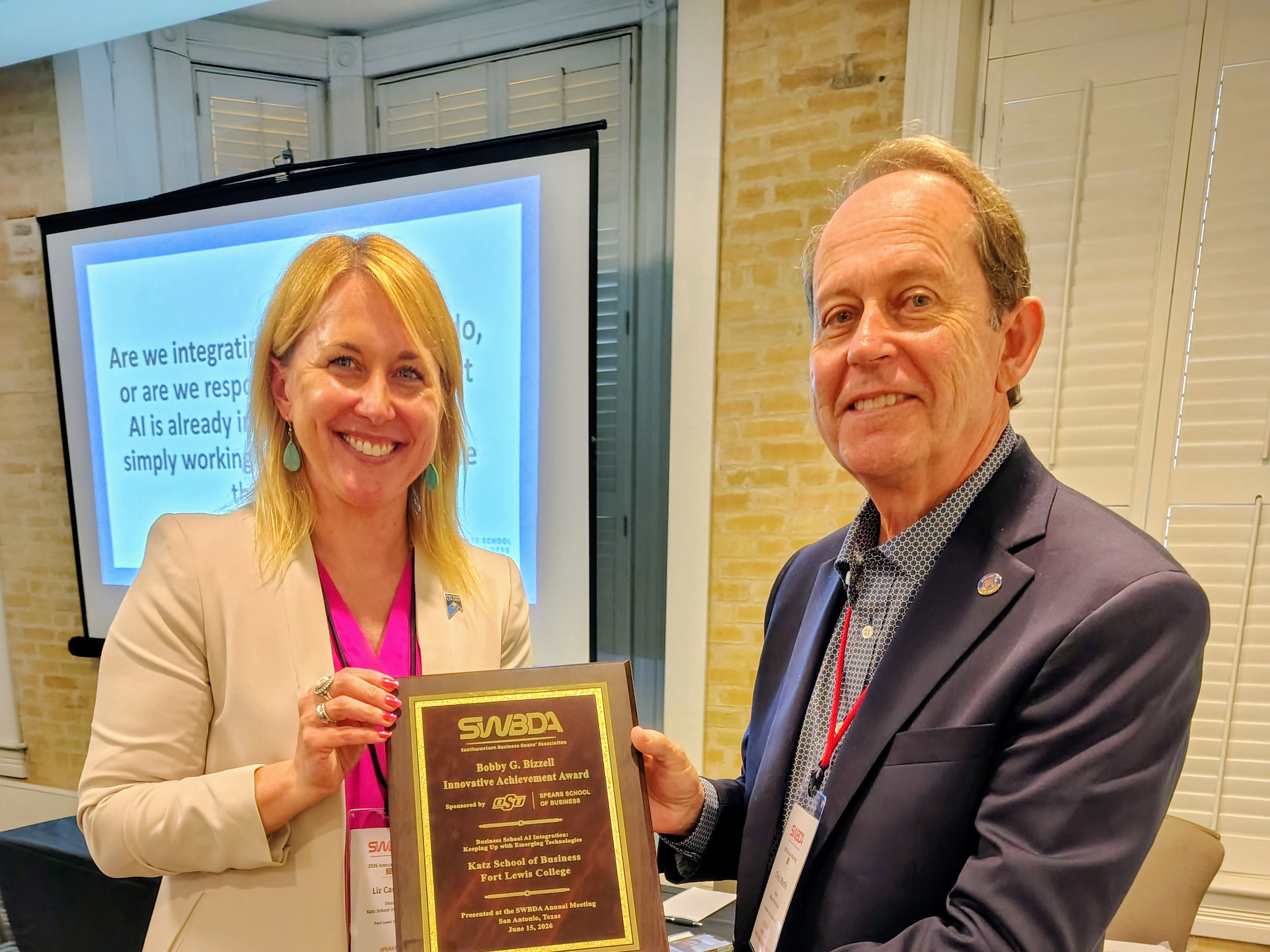 Liz Cartier accepts the Bobby G. Bizzell Innovative Achievement Award plaque.