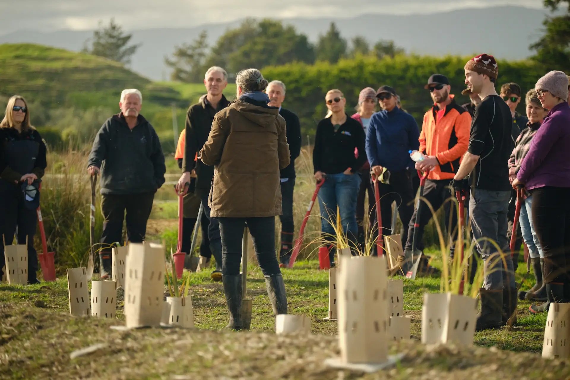 A group of people gather at Parahamuti to discuss the restoration project.