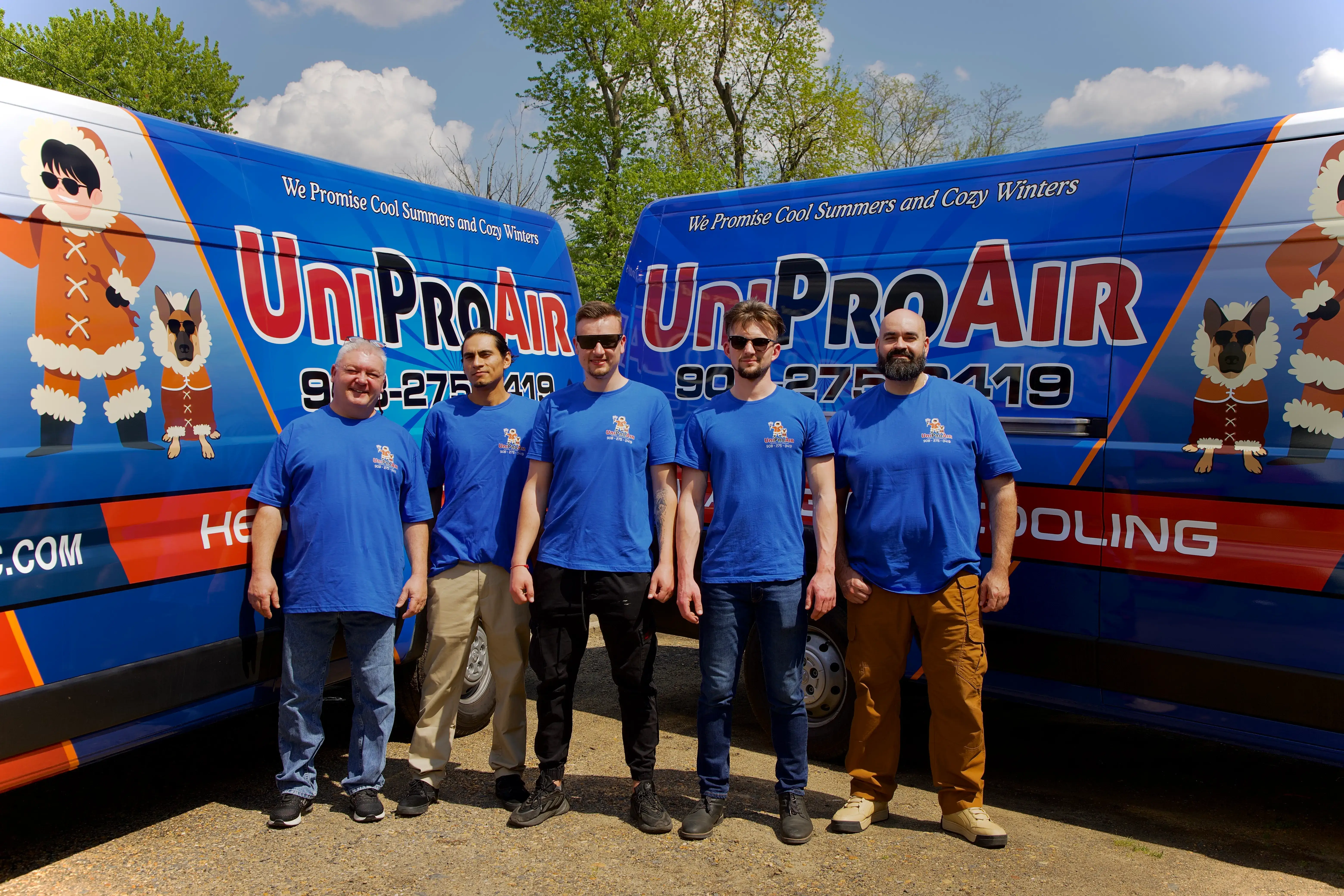 Five UniProAir team members posing in front of blue company service van