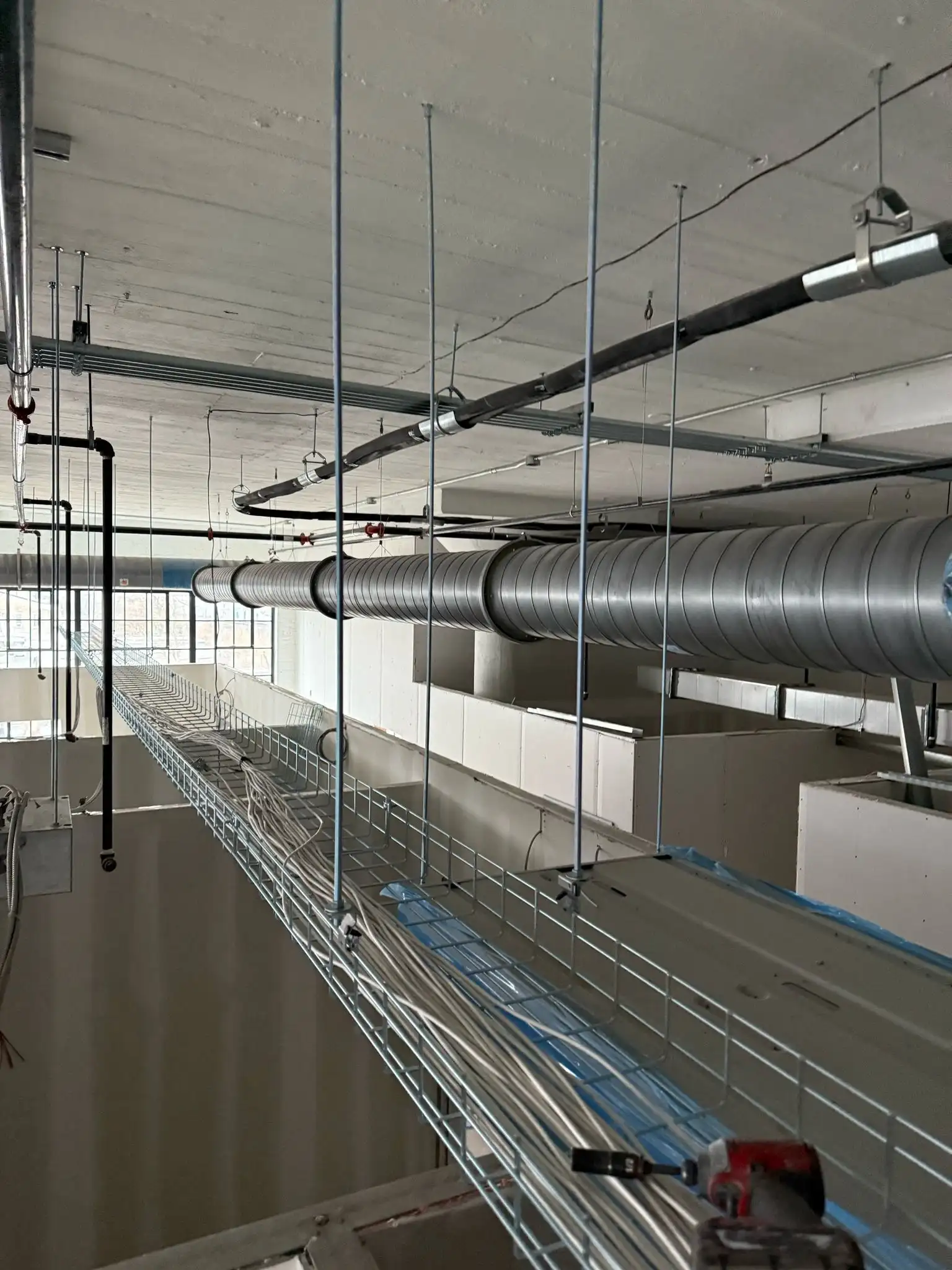 Long HVAC duct lines running across a commercial ceiling