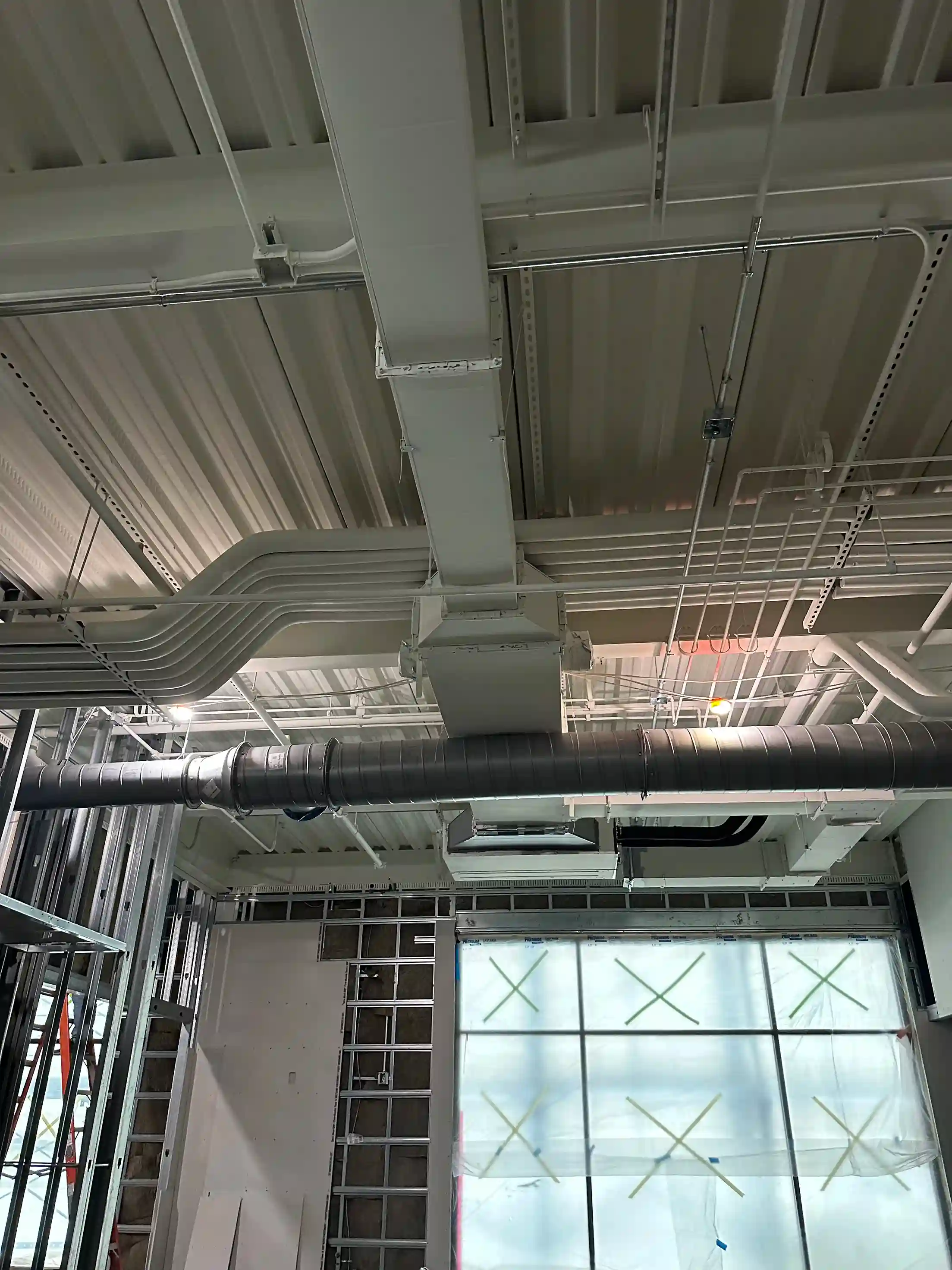 Close-up of air ducts and structural ceiling elements in an HVAC system buildout