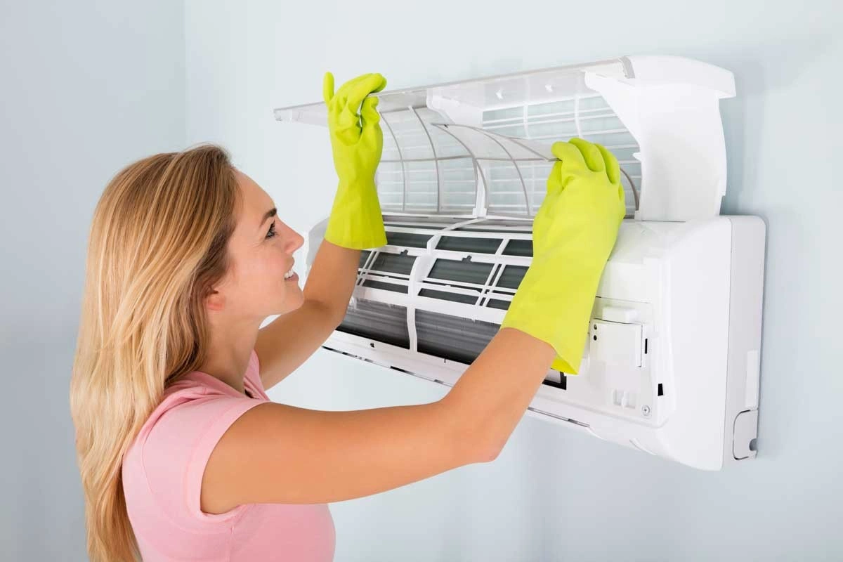 People cleaning filters of air conditioners.