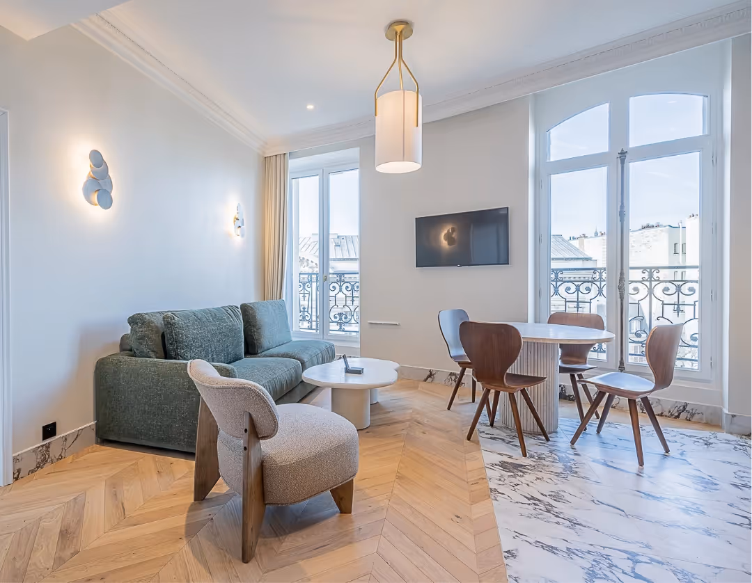 Bright living room with dining table in a furnished apartment for long-term business rental, Yuna.