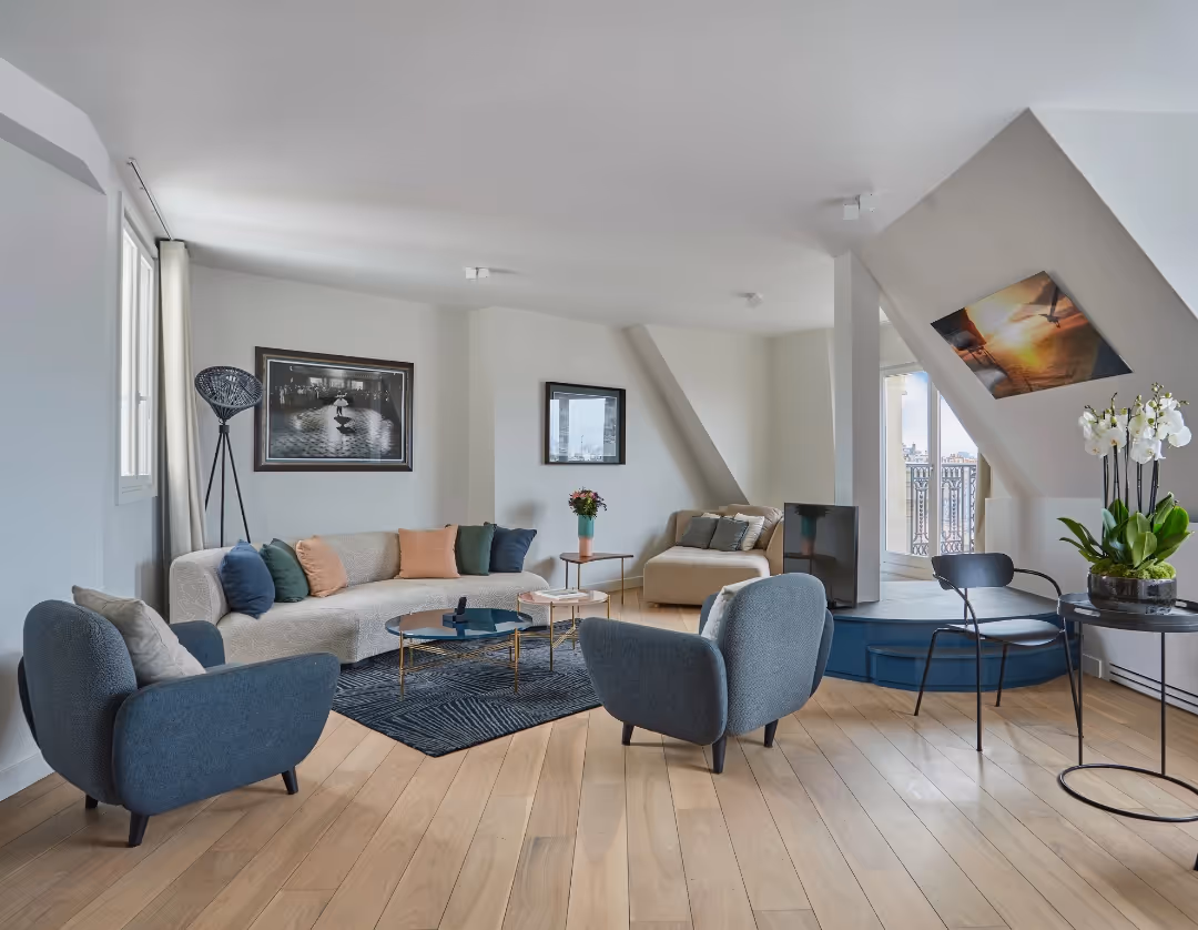 Living room decorated with numerous paintings in an apartment hotel furnished for business stays, Yuna.