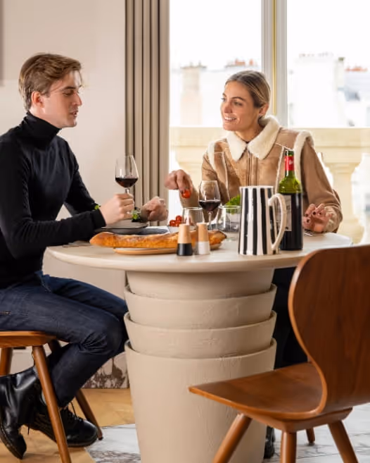 Couple dining in a furnished apartment hotel for long term rental, Yuna.