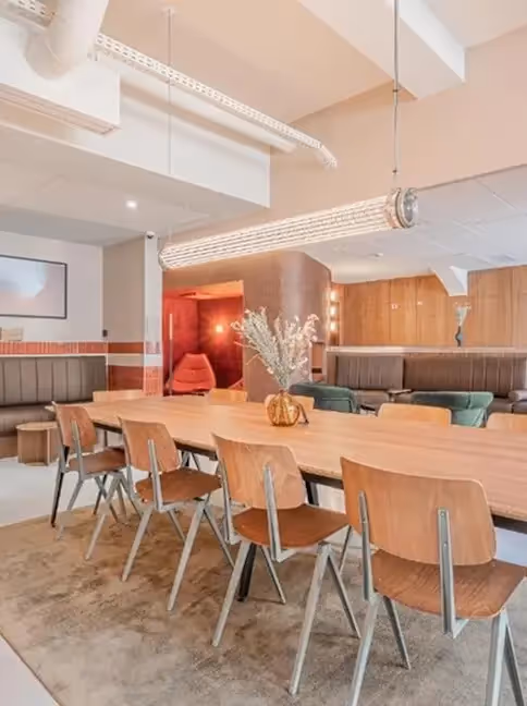 Large wooden table in a furnished apartment for business stays and long-term rentals, Yuna.