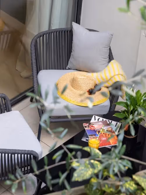 Two people playing cards in a furnished short-term rental apartment, Yuna.