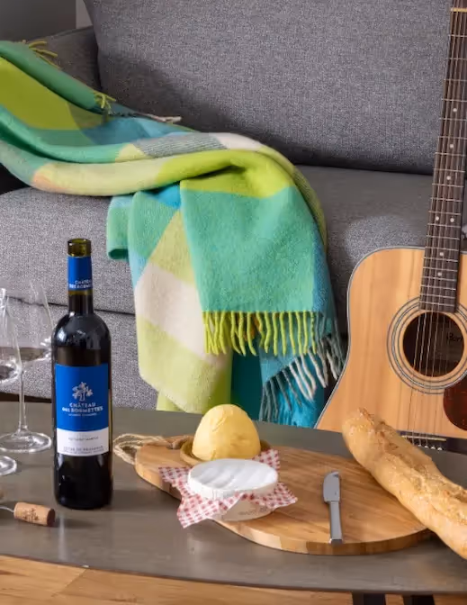 Cheese platter with glass of wine in a furnished business apartment, Yuna.