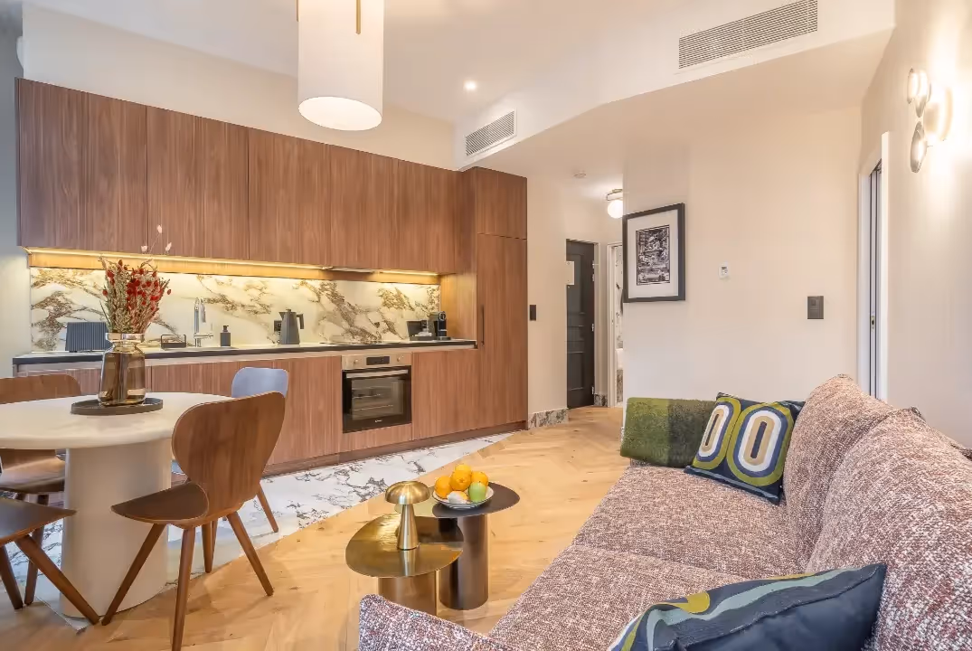Overview of the living room and kitchen in a furnished short-term business rental apartment, Yuna.