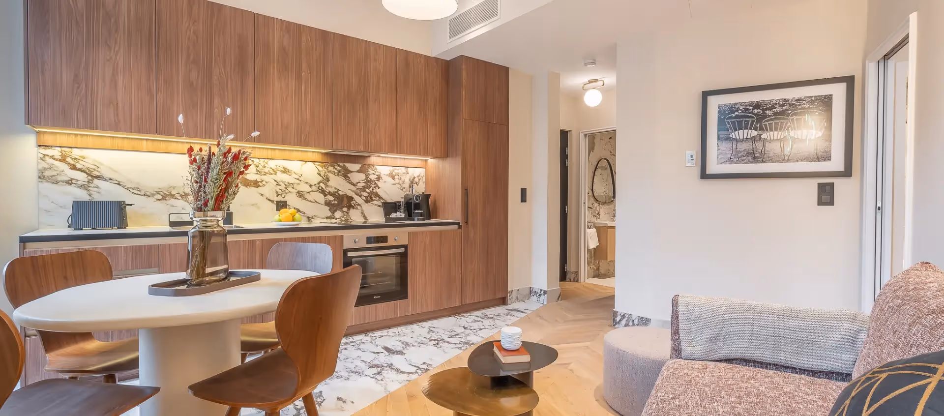 Living room and kitchen all in marble in a furnished apartment for short term rental and corporate housing, Yuna.