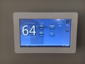 Two gray water heaters with red labels.