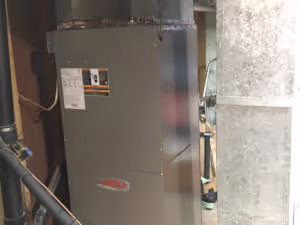 Two gray water heaters with red labels.
