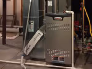Two gray water heaters with red labels.