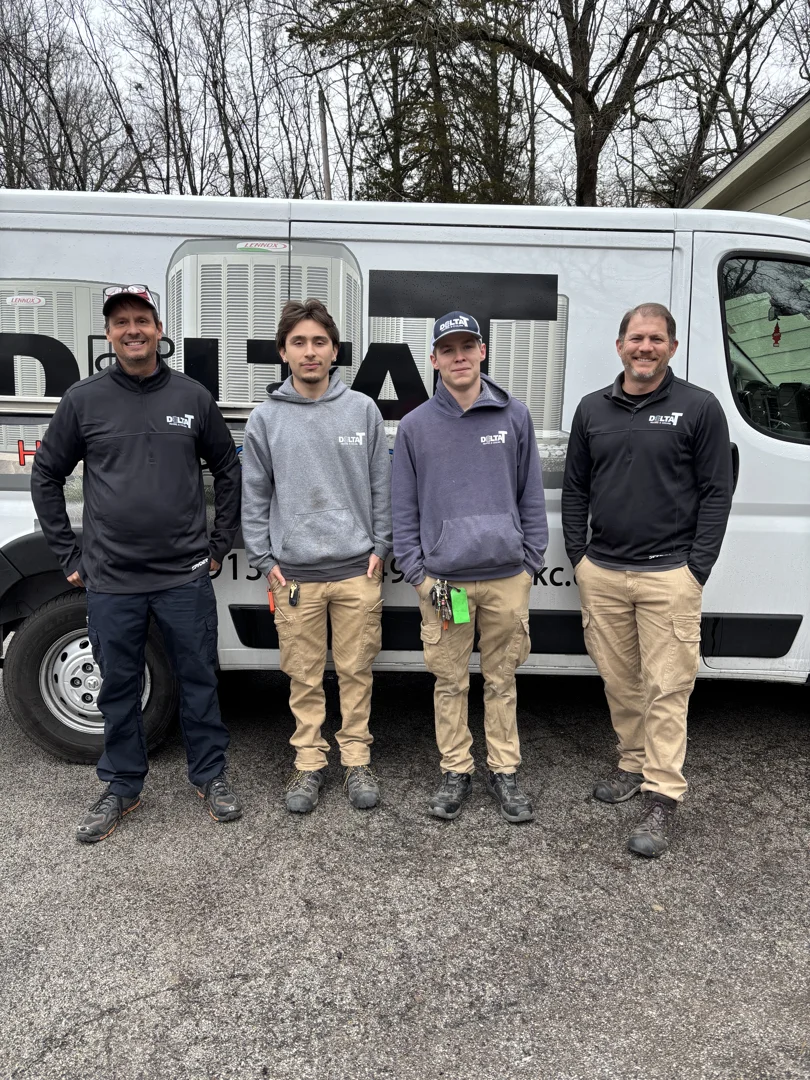 HVAC technician in a clean uniform using a tablet and tape measure to calculate the square footage of a living room for a