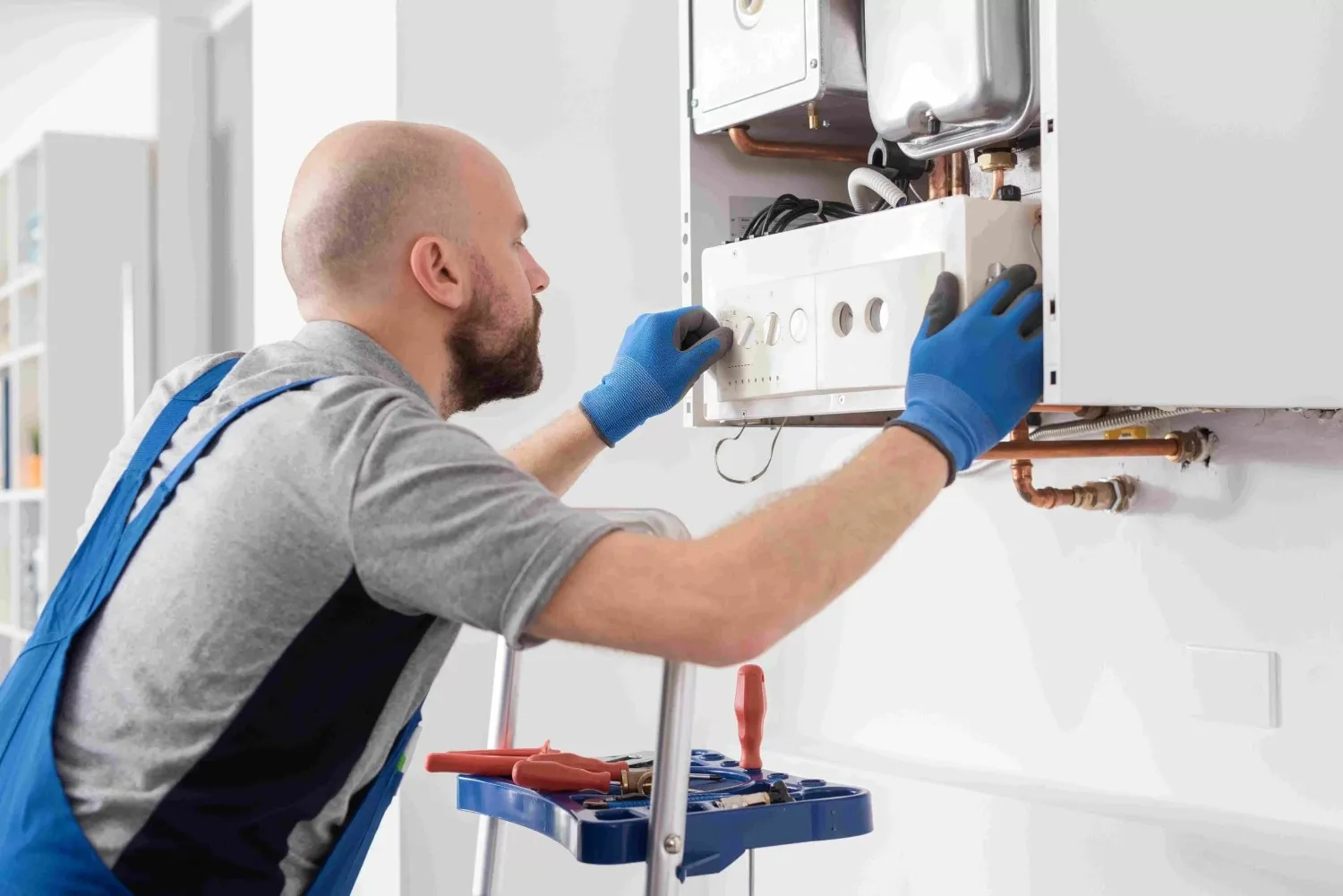 Technician fixing internal component of a boiler.