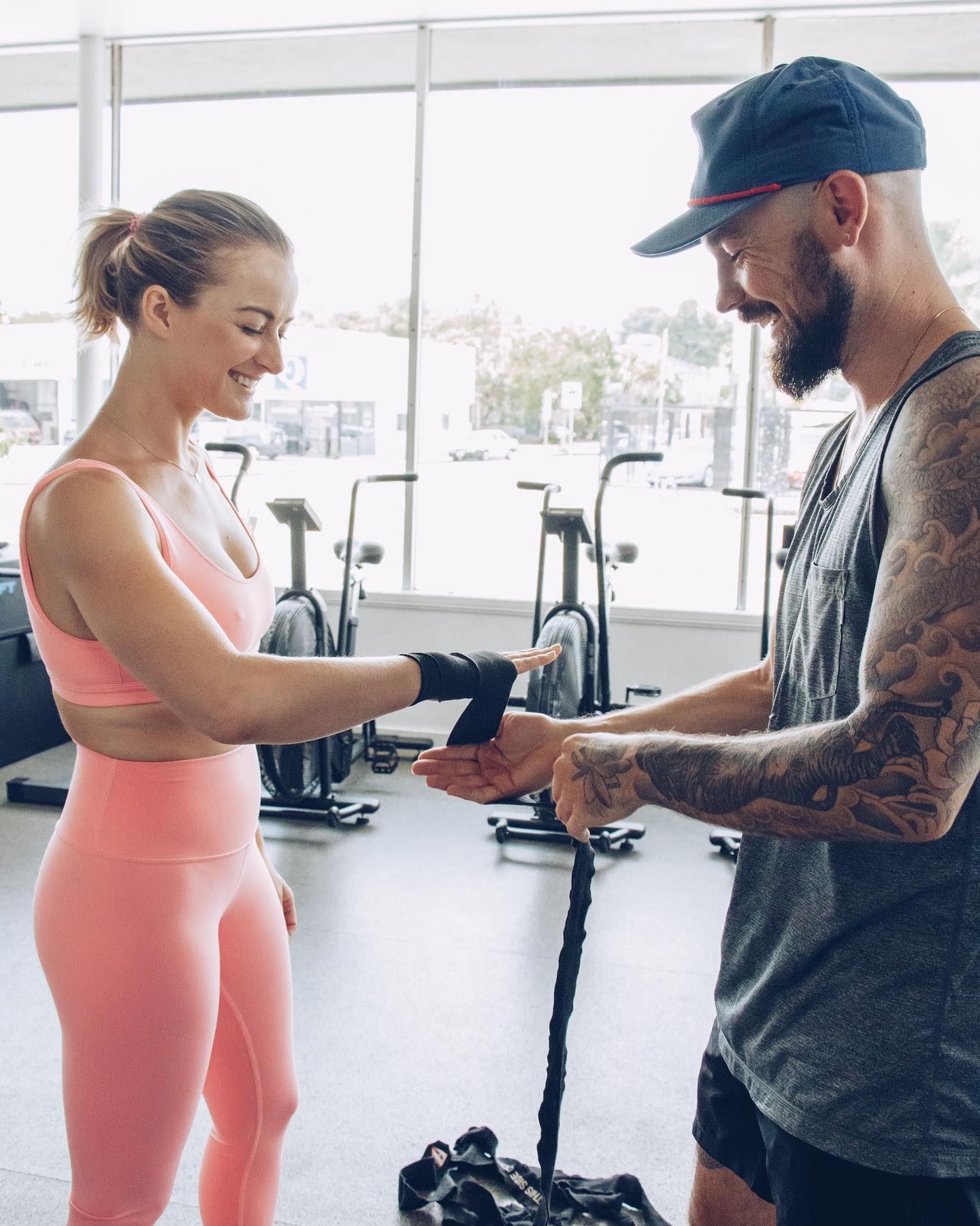 A coach helping a first-time student wrap her hands