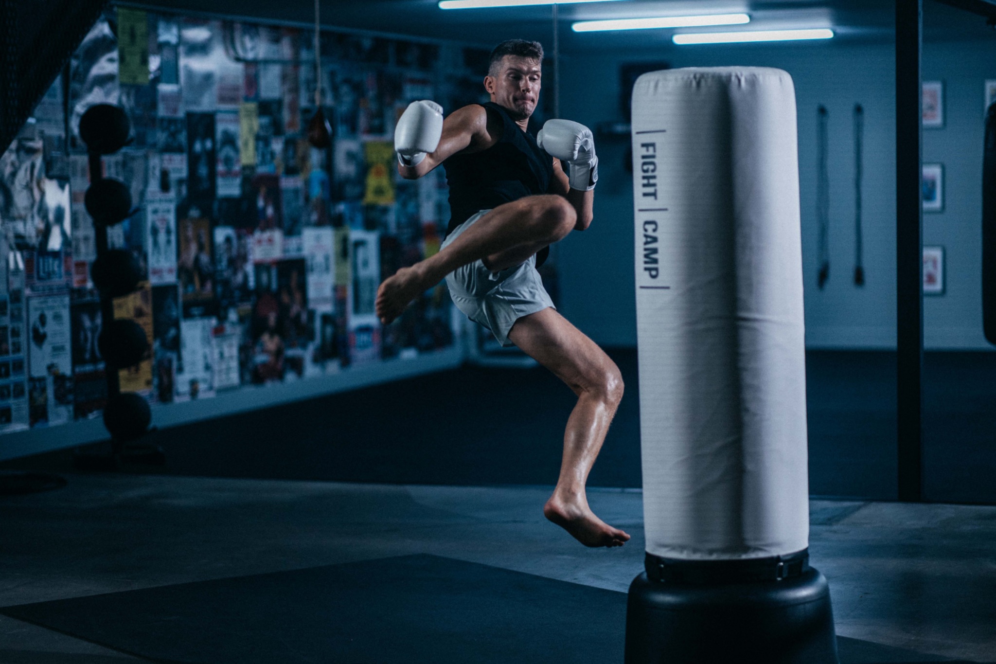 Coach Aaron demonstrating a kick on a heavy bag