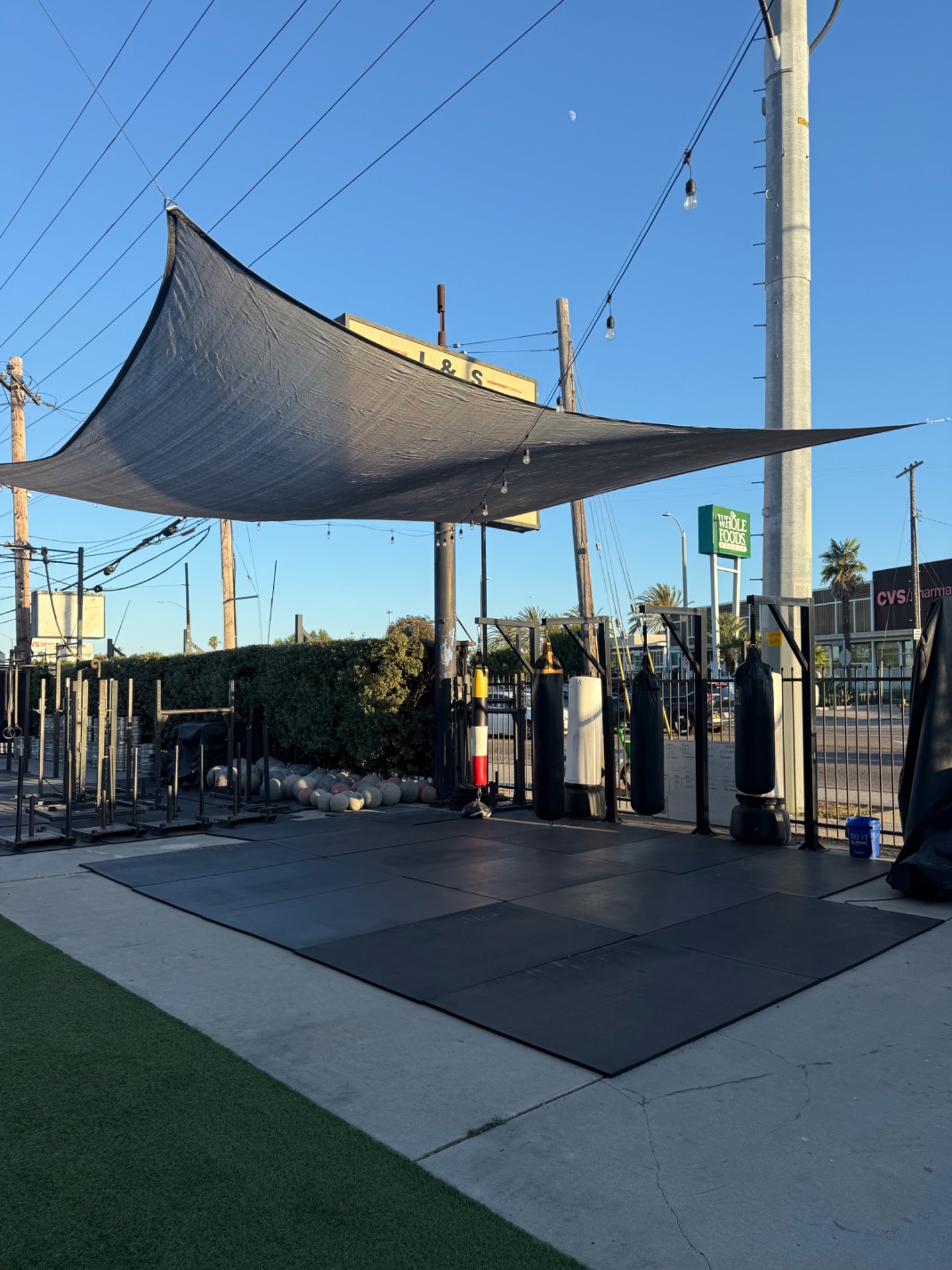 The outdoor training space and shade canopy at Deuce Gym in Venice